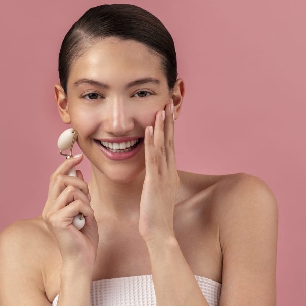front-view-smiley-woman-using-face-roller front-view-smiley-woman-using-face-roller